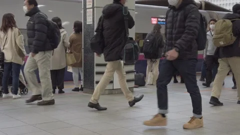 People walking at the Shinkansen platform at Tokyo Station. Slow motion Stock Footage 167573387
