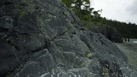 People walking on shore at Deception Pass Bridge State Park Washington Stock Footage 73526656