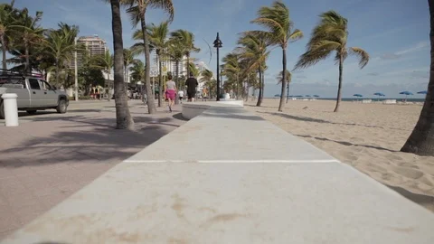 People Walking On Sidewalk By Beach Video stock 102129031