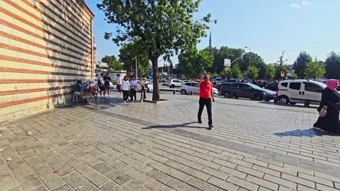 People walking on a sidewalk in a. Stock Footage 282679955