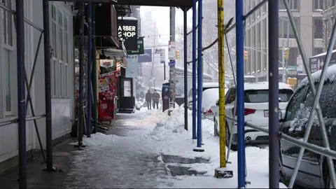 People walking in the snow in SoHo Stock Footage 147641384