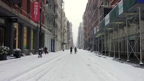 People walking in the snow in SoHo Stock Footage 147641399