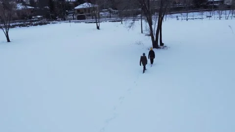 People walking on the snow to the tree Stock Footage 158547629