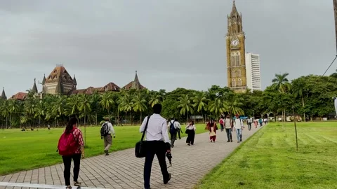 People walking on the square Rajabai Clock Tower on background. Stock Footage 248408523