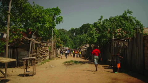 People walking in street with camera centered, Betou, Congo Видео 338167513