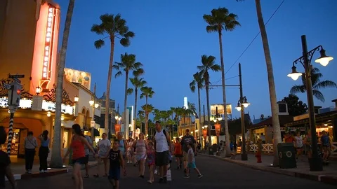 People walking on Sunset Boulevard on blue night background at Epcot Stock Footage 109170612
