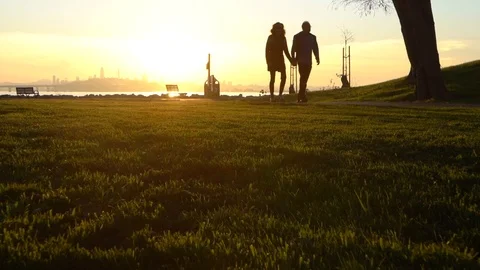 People walking at sunset 스톡 동영상 99836883