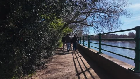 People walking on Thames Path along River Thames on a sunny morning Stock Footage 332677822