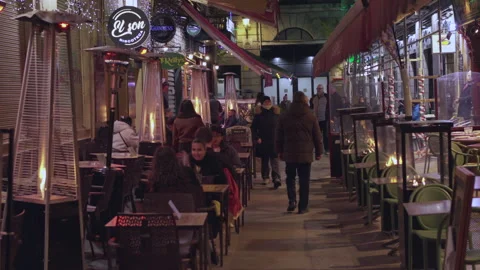 People walking through bustling restaurant alley at night Stock Footage 322535856