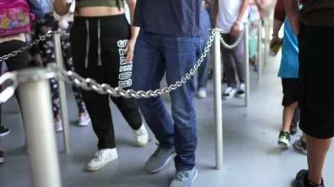 People walking through a chained line Stock Footage 197012208