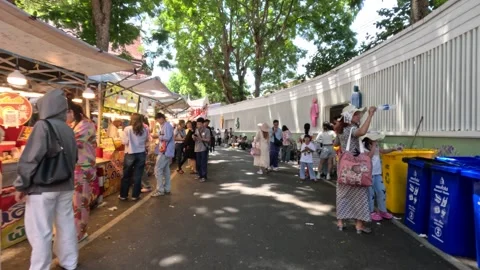 People Walking Through Crowded Outdoor Food Market in Sunlight Stock Footage 345476667