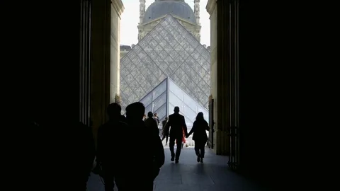 People walking through dark corridor Le Louvre pyramid in Paris France 1080 Stock Footage 94064184