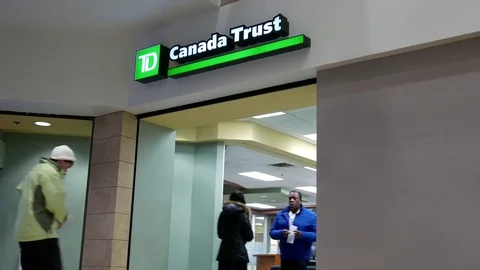 People walking through door at main entrance inside TD bank 스톡 동영상 73192935
