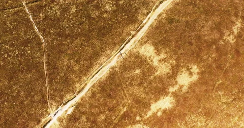 People walking through the dune ladscape straight down going up aerial Stock Footage 153519374