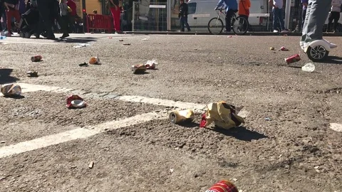 People walking through garbage left in the street of Valencia after celebrating Stock Footage 75191771