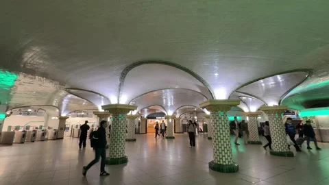 People walking through the iconic Cité metro station in Paris, France Stock Footage 337784326