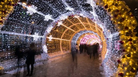 People walking through the New Year and Christmas holidays light tunnel in the Stock Footage 85329326