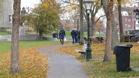 People walking through a park Stock Footage 98107483