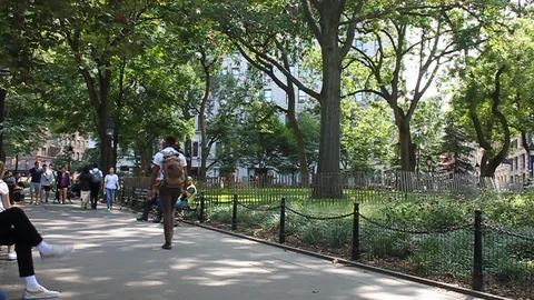 People walking through park on Sunny Day in New York City Stock Footage