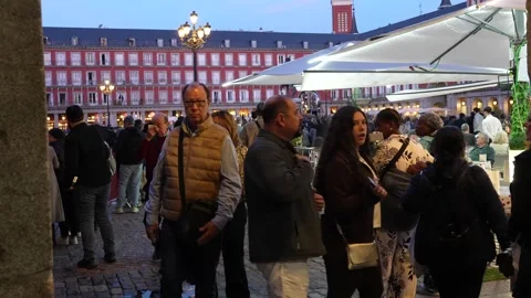 People walking through Plaza Mayor at dusk in Madrid Stock Footage 334331503