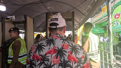 People Walking Through Police Security Checkpoint at Street Festival Stock Footage 345767332