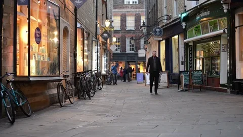 People walking through Rose Crescent past shops, Cambridge UK Stock Footage 79549426