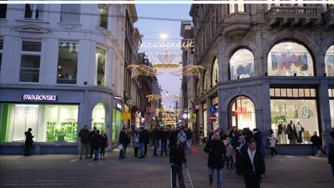 People walking through a shopping district on a street called Nieuwendijk w.. Stock Footage 259030588
