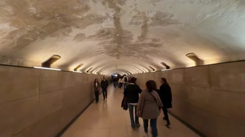 People walking through the Souterrain Étoile underground tunnel in Paris Stock Footage 337783283