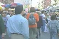 People walking through a street market in Little Italy Footage