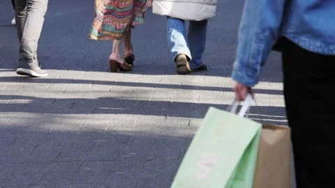 People Walking Through Sunlit Patch On City Street Stock Footage 304845881