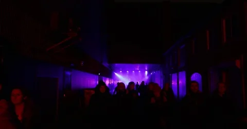 People walking through a tunnel with blue lights, 4K Stock Footage 82390439