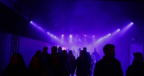 People walking through a tunnel with blue lights, 4K Stock Footage 82390499