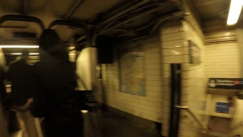 People walking through turnstiles inside New York City Subway on Manhattan 動画素材 77312681