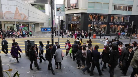 People walking through a zebra crossing before vehicles at a street in downtown Stock Footage 45379694