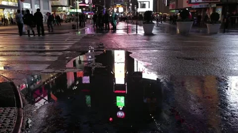 People walking in Times Square with puddle reflections Stock Footage 20615034