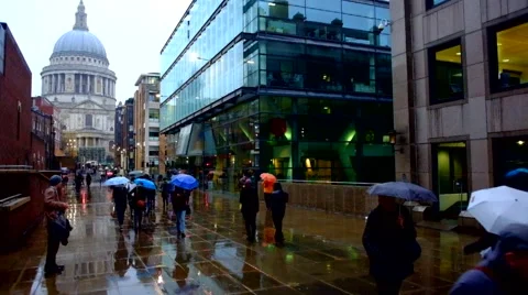 People Walking with umbrellas in the rain Stock Footage