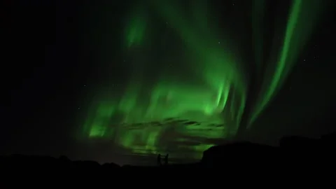People walking under active aurora borealis real-time video Stock Footage 164607754