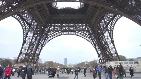 People walking under the Eiffel Tower, Paris Stock Footage