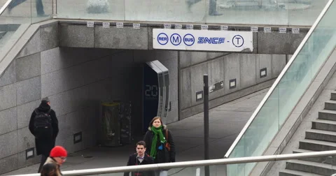 People walking under the logo of SNCF in Paris, France La Defense Stock Footage 56628552