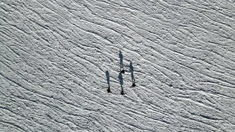 People walking on a winter ice covered textured snow lake, Aerial frozen sea 4k Stock Footage 220733341