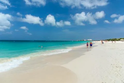 People walks in an idyllic tropical beach. Stock Photos