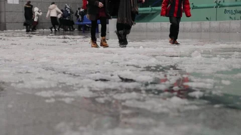 People in warm boots goes through snow ice during abnormal weather in Jerusalem Stock Footage 170611524