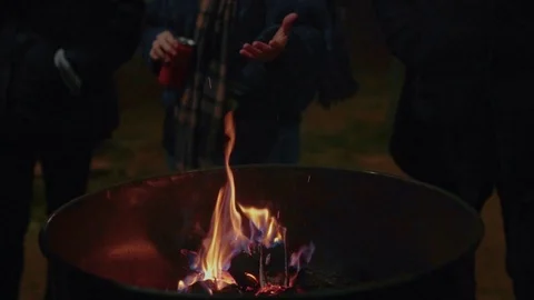 People warm hands next to fire on street Stock Footage 86366601