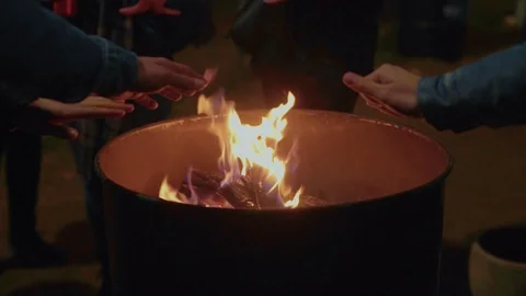 People warm hands next to fire on street Stock Footage 86366623
