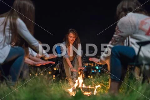 The people warming hands near bonfire. night time Stock Photos