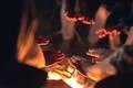 The people warming hands near the bonfire. night time Photo