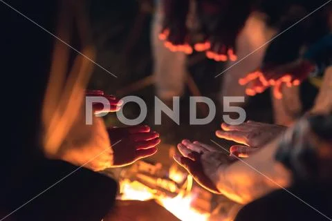 The people warming hands near the bonfire. night time Stock Photos