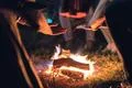 The people warming hands near the bonfire. night time Photo