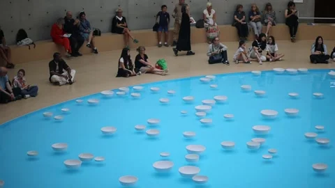 People watching art installation with floating bowls in Paris Stock Footage 316818773