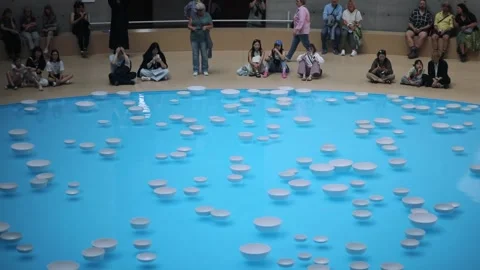 People watching art installation with floating bowls in Paris Stock Footage 316818783